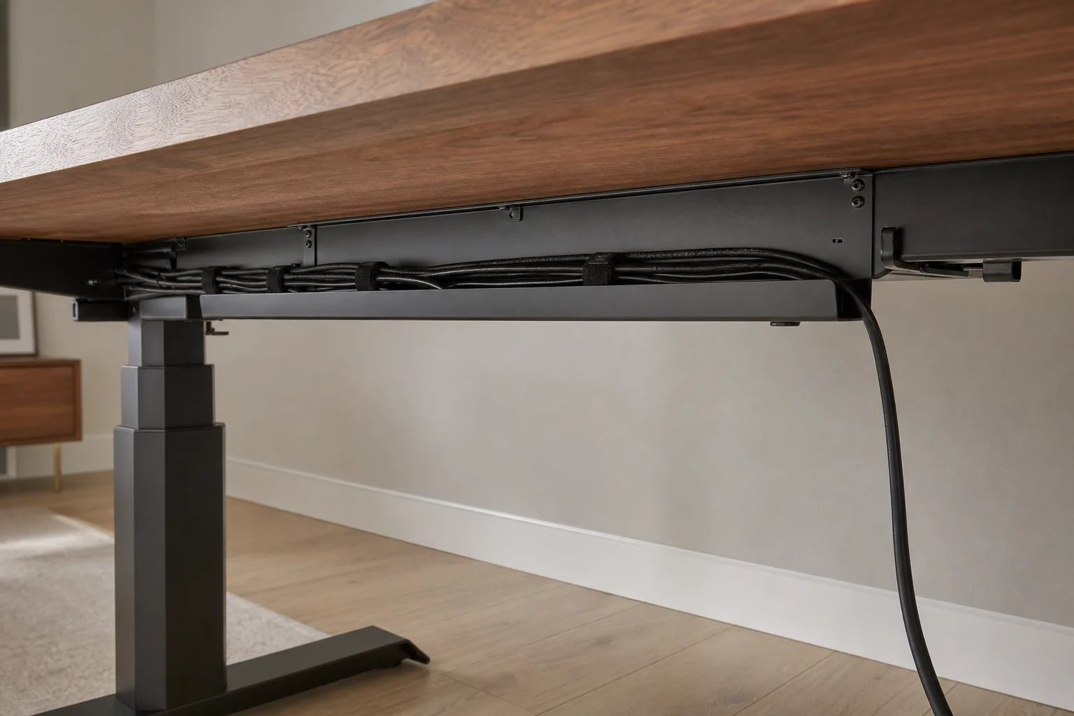 Neatly routed cables beneath a sit-stand home-office desk